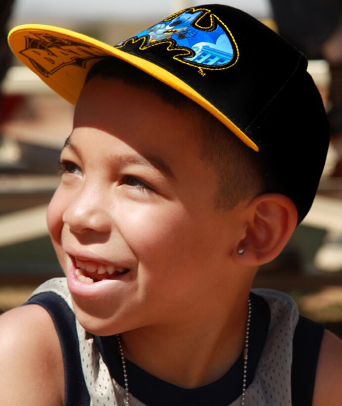 Jayden Molina, 6, son of Gunnery Sgt. Jose Molina, with Combat Logistics Battalion 7, watches a military working dog demonstration during the L.I.N.K.S. CAX for Kids program April 25, 2013. (Official USMC photo by Cpl. William J. Jackson/Released)
