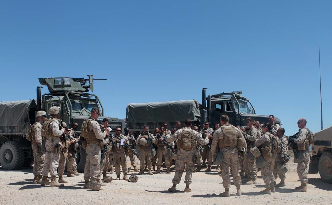 Marines and sailors with Truck Company Alpha, Headquarters Battalion, 1st Marine Division, listen to a brief after conducting convoy training here, May 3, 2013. The company hit a simulated improvised explosive device and conducted immediate action drills to recover the stranded Marines and vehicle.(U.S. Marine Corps photo by Sgt. Jacob H. Harrer)