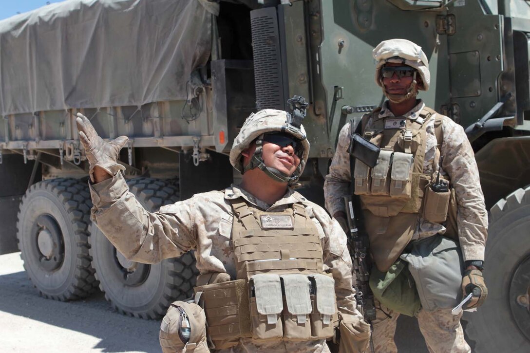 Corporal Marco A. Lizarraga, a motor transport operator with Truck Company Alpha, Headquarters Battalion, 1st Marine Division, describes his surprise as his vehicle was struck by a simulated improvised explosive device here, May 3, 2013. Lizarraga, a 25-year-old native of Tucson, Ariz., failed to spot the device, which his training chief had hidden among rocks and sand.(U.S. Marine Corps photo by Sgt. Jacob H. Harrer)