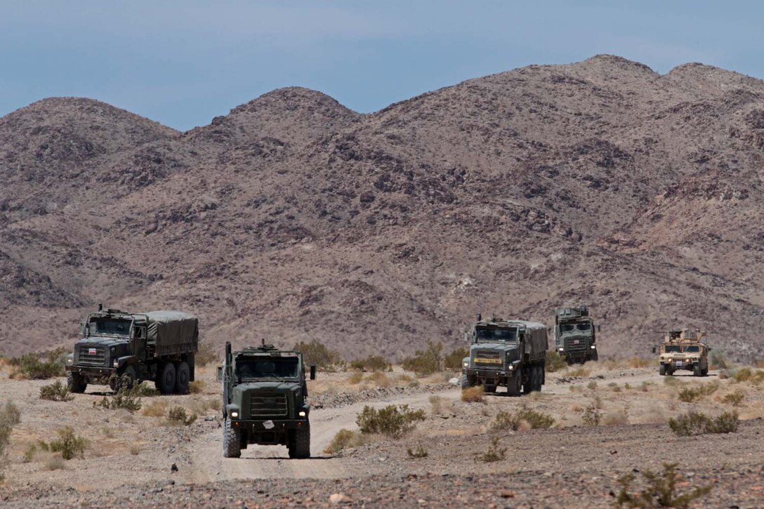 A training convoy halts after their second vehicle was struck by a simulated improvised explosive device here, May 3, 2013. Marines with Truck Company Alpha, Headquarters Battalion, 1st Marine Division, participated in convoy training to improve their ability to identify IEDs and respond quickly and effectively to strikes.(U.S. Marine Corps photo by Sgt. Jacob H. Harrer)
