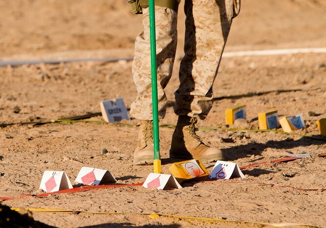 Lieutenant Col. Thomas Freel, the future operations officer for 5th Marine Regiment, 1st Marine Division, points out notional enemy locations on a terrain model for a rehearsal of concept drill during Exercise Desert Scimitar here, May 2, 2013. Desert Scimitar is a combined arms exercise focused on the training and preparation of 1st Marine Division for deployment as the ground combat element of a Marine Air-Ground Task Force. Freel, a native of Grosse Ile, Mich., said the exercise is a return to live-fire combined arms tactics training which has been overshadowed by the focus on counterinsurgency operations training throughout the past decade. The "Fighting Fifth" exercised traditional warfare command and control tactics over infantry, artillery and armored assets during Desert Scimitar.