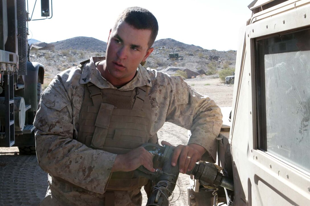 Lance Cpl. Justin L. Carson, a motor transport operator serving with Headquarters Battalion, 1st Marine Division, refuels a Humvee during Exercise Desert Scimitar here, May 3, 2013. Carson, a 20-year-old native of Bailey, Colo., used a hose from the Mk27 refueler truck, a self-contained gas station capable of transporting roughly 2,000 gallons of fuel.(U.S. Marine Corps photo by Sgt. Jacob H. Harrer)