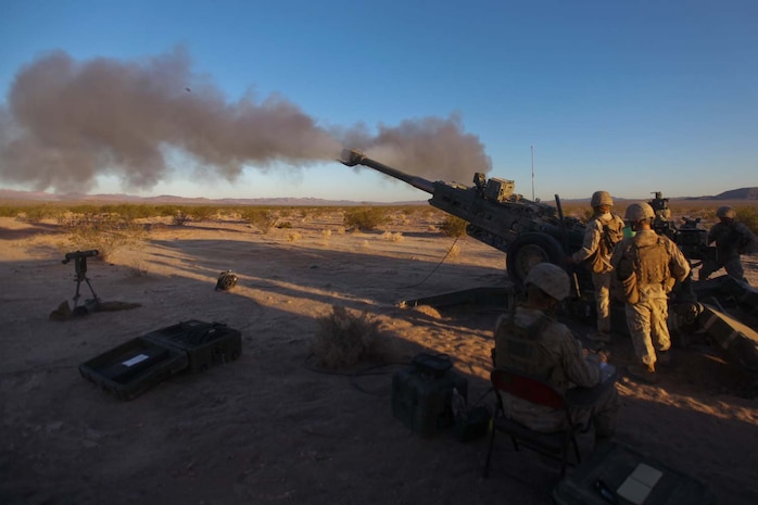 Marines serving with Kilo Battery, 3rd Battalion, 12th Marine Regiment, attached to 2nd Battalion, 11th Marines, launch high-explosive rounds at a target during Exercise Desert Scimitar here, May 3, 2013. The Marines worked 24-hour operations, conducting fire missions and movements throughout the day.