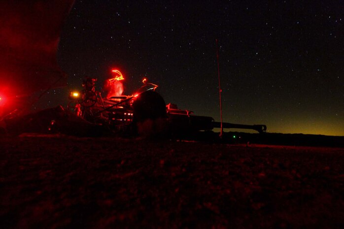 Marines serving with Kilo Battery, 3rd Battalion, 12th Marine Regiment, attached to 2nd Battalion, 11th Marines, lower the barrel of their M777 Lightweight Howitzer, after a night fire mission here, May 3, 2013. The Marines clean the weapon after every fire mission.
