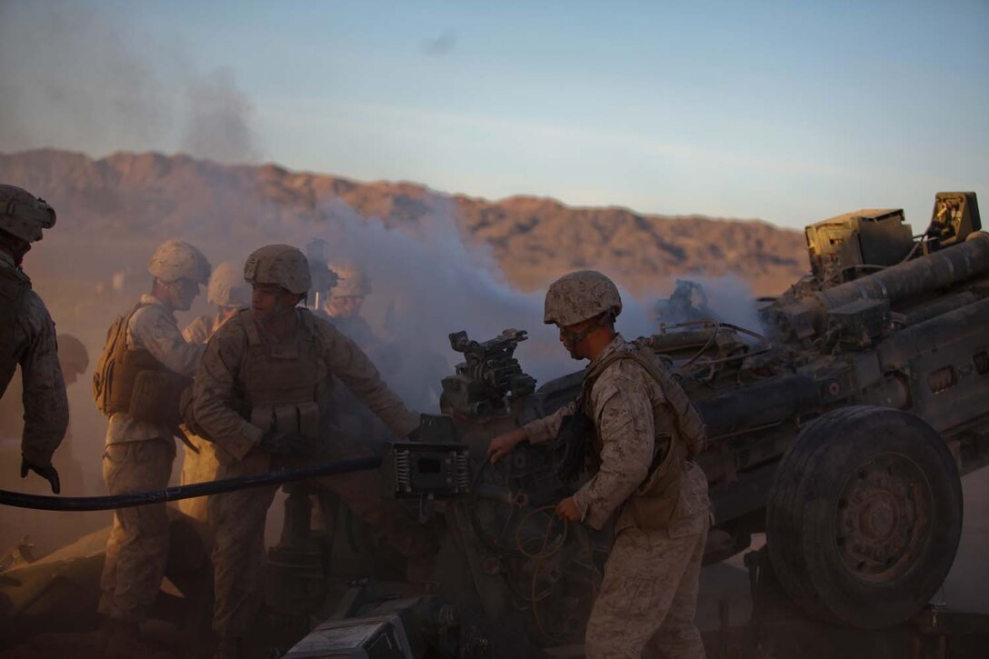 Marines serving with Kilo Battery, 3rd Battalion, 12th Marine Regiment, attached to 2nd Battalion, 11th Marines, prepare to load a round into an M777 Lightweight Howitzer as the smoke clears from an earlier fire here, May 3, 2013. The regiment participated in Exercise Desert Scimitar, focusing on supporting the infantry with high-explosive and illumination rounds.