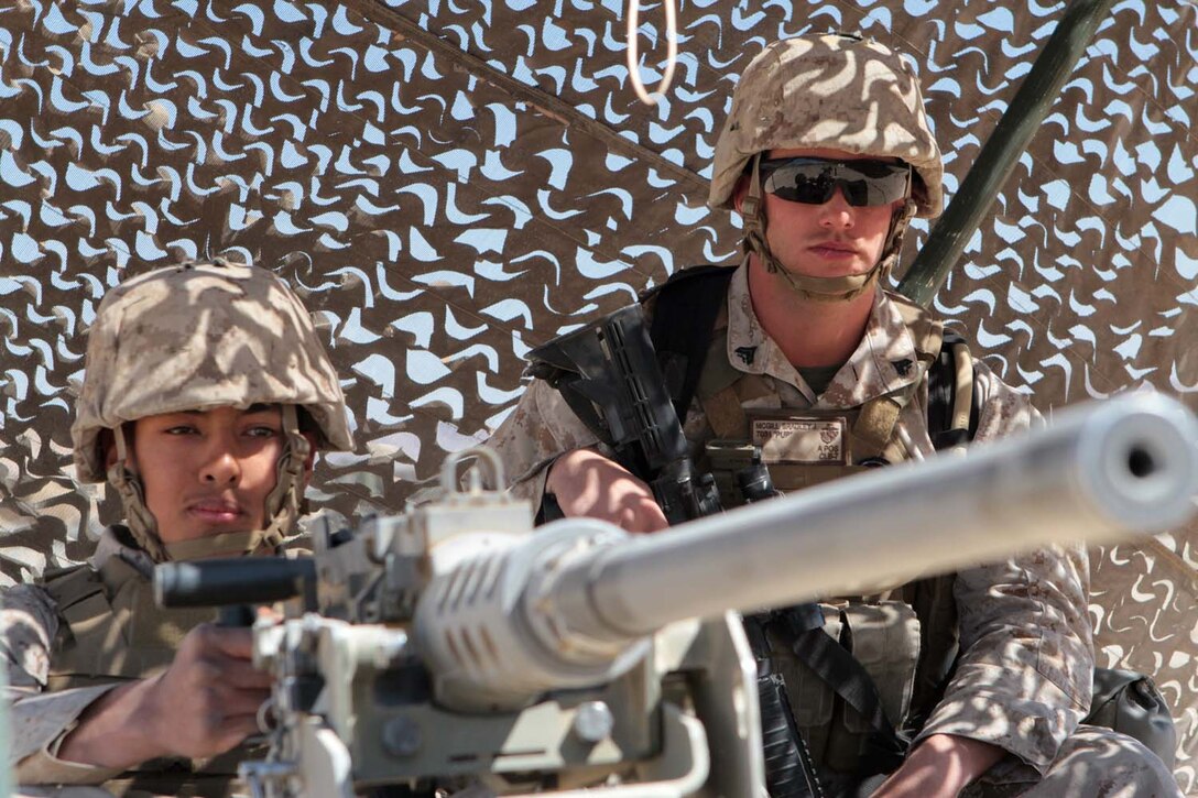 Lance Cpl. Luis Roman-Garcia, a landing support specialist serving with Combat Logistics Regiment 1, 1st Marine Logistics Group, and Cpl. Bradley J. McGill, a motor transport operator serving with CLR-1, man a security outpost during Exercise Desert Scimitar here, May 2, 2013. Roman-Garcia, a 19-year-old native of Omaha, Neb., and McGill, a 22-year-old native of Lexington, Tenn., were attached to 1st Marine Division to provide security during the two-week exercise. (U.S. Marine Corps photo by Sgt. Jacob H. Harrer)