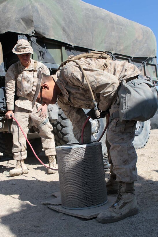 Private First Class Frederick Alaniz, a motor transport operator serving with Headquarters Battalion, 1st Marine Division, cleans an air filter during Exercise Desert Scimitar here, May 2, 2013. Alaniz, a 19-year-old native of Alta, Calif., used compressed air to blow dust and debris out of the filter. Drivers perform basic maintenance for their vehicles to keep them running and often assist the mechanics with more complex tasks.(U.S. Marine Corps photo by Sgt. Jacob H. Harrer)