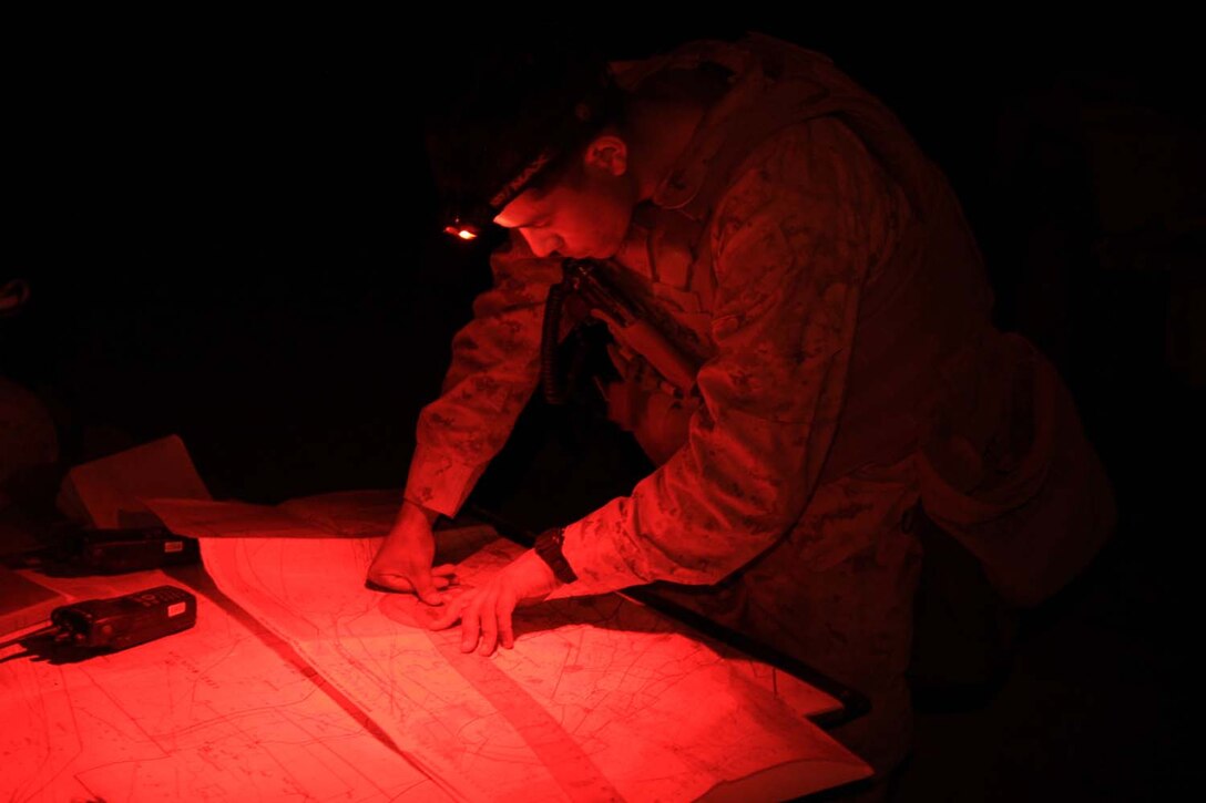 Second Lt. Pascual Eley, a fire directions officer serving with 2nd Battalion, 11th Marine Regiment, and a native of Fullerton, Calif., helps members of the fire direction center convert target data into firing commands for the gunline during Exercise Desert Scimitar, a combined-arms, live-fire training exercise here, May 2, 2013. The FDC's job is to take the information given to them by forward observers and compute how wind, air pressure, temperature, humidity and other weather conditions will effect an artillery round while airborne.