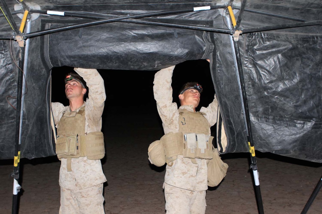 Corporal Tyler Harden (left), a radio operator serving with 2nd Battalion, 11th Marine Regiment, and a native of Jacksonville, Fla., and Lance Cpl. Edward King, a data computer and native of Pittsburgh, break down the fire direction center before moving to a new training destination during Exercise Desert Scimitar, a combined-arms, live-fire training exercise here, May 2, 2013. The battalion was mobile and performed live-fire training exercises from many different locations throughout the entirety of the exercise.