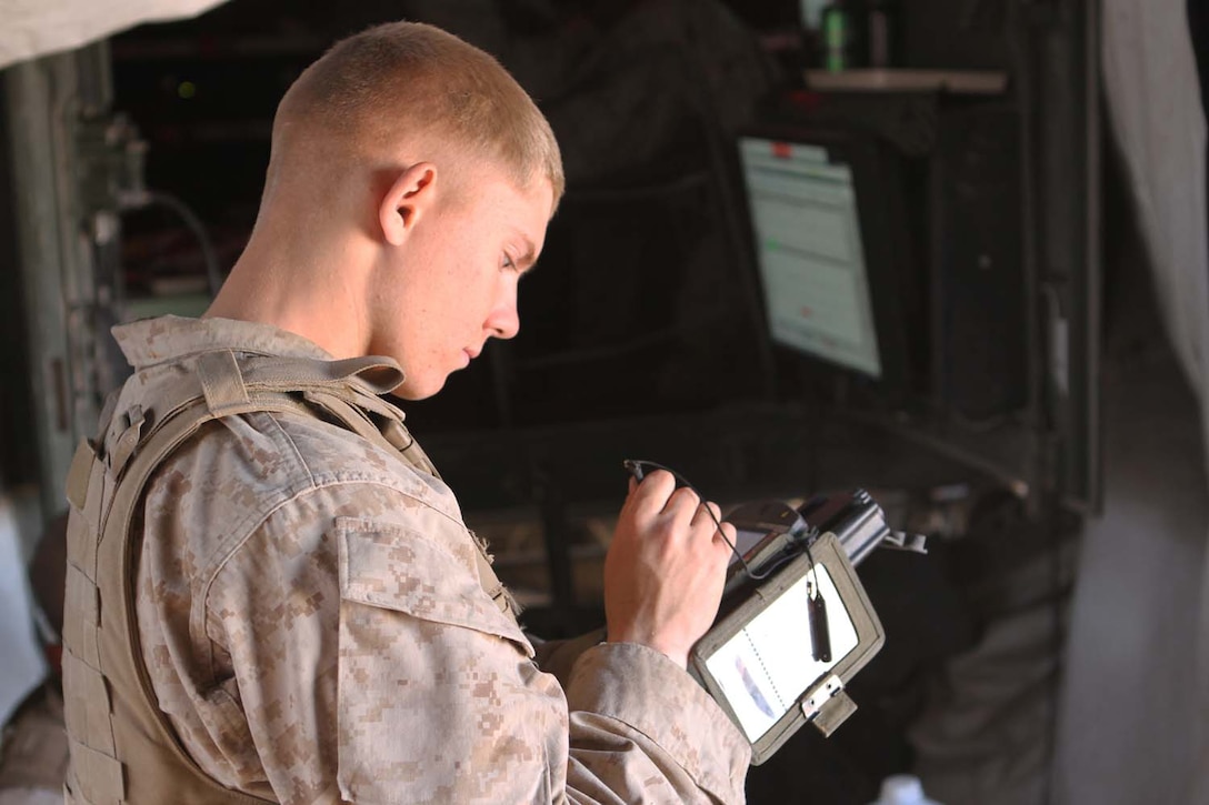 Lance Cpl. Joshua Ratzlaff, a chart operator serving with 2nd Battalion, 11th Marine Regiment, and a native of Spokane, Wash., helps members of the fire direction center convert target data into firing commands for the gunline during Exercise Desert Scimitar, a combined-arms, live-fire training exercise here, May 2, 2013. The FDC's job is to take the information given to them by forward observers and compute how wind, air pressure, temperature, humidity and other weather conditions will effect an artillery round while airborne.