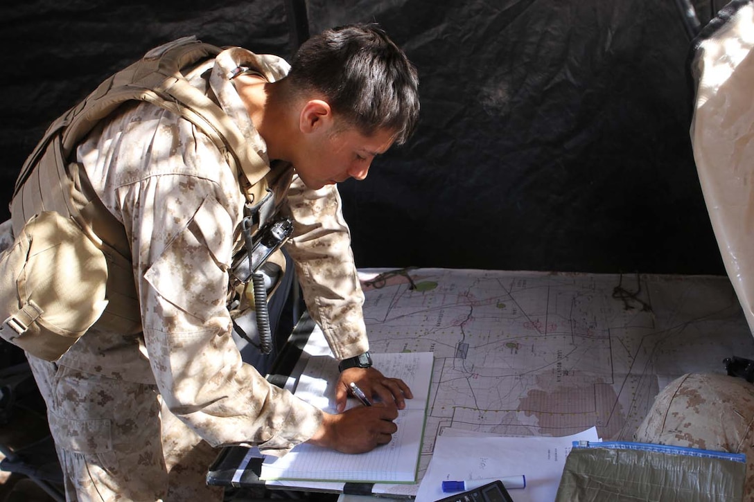 Second Lt. Pascual Eley, a fire directions officer serving with 2nd Battalion, 11th Marine Regiment, and a native of Fullerton, Calif., helps members of the fire direction center convert target data into firing commands for the gunline during Exercise Desert Scimitar, a combined-arms, live-fire training exercise here, May 2, 2013. The FDC's job is to take the information given to them by forward observers and compute how wind, air pressure, temperature, humidity and other weather conditions will effect an artillery round.