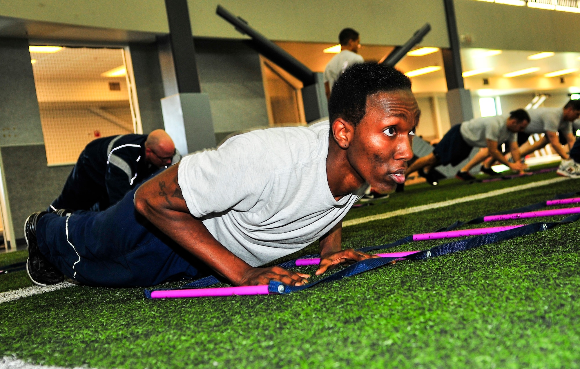 U.S. Air Force Airman 1st Class Dominick Flowers, 354th Contracting Squadron contracting specialist, executes proper pushup form during a physical training leader class at the fitness center May 7, 2013, Eielson Air Force Base, Alaska. The PTL class, provided by the Health and Wellness Center, is a two-day course for motivated active duty members to help their peers excel in physical fitness. (U.S. Air Force photo by Racheal E. Watson/Released)