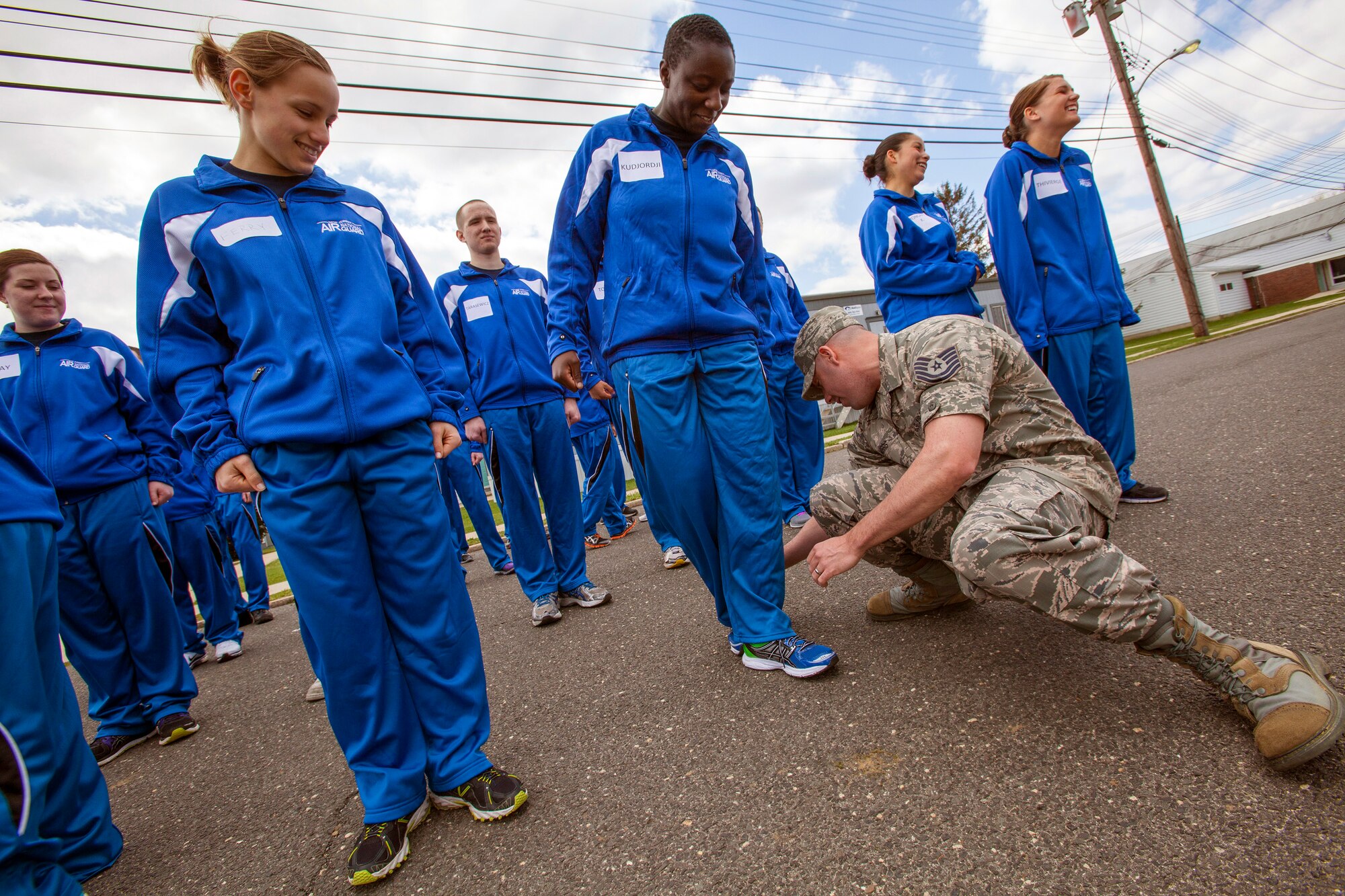 Tech. Sgt. James Morris a recruiter with the 177th Fighter Wing, explains the about face movement to Edana A. Kudjordji, 108th Wing Student Flight member, April 13, 2013, at the National Guard Training Center in Sea Girt, N.J. Forty-four members of the New Jersey Air National Guard Student Flight spent a weekend in a simulated basic training environment preparing them for military culture April 13 and 14.  Student Flight gives new enlistees a head start on basic military training, making the transition from civilians into Airmen easier from the time of enlistment until the time they leave for BMT.  (U.S. Air National Guard photo by Master Sgt. Mark C. Olsen/Released)