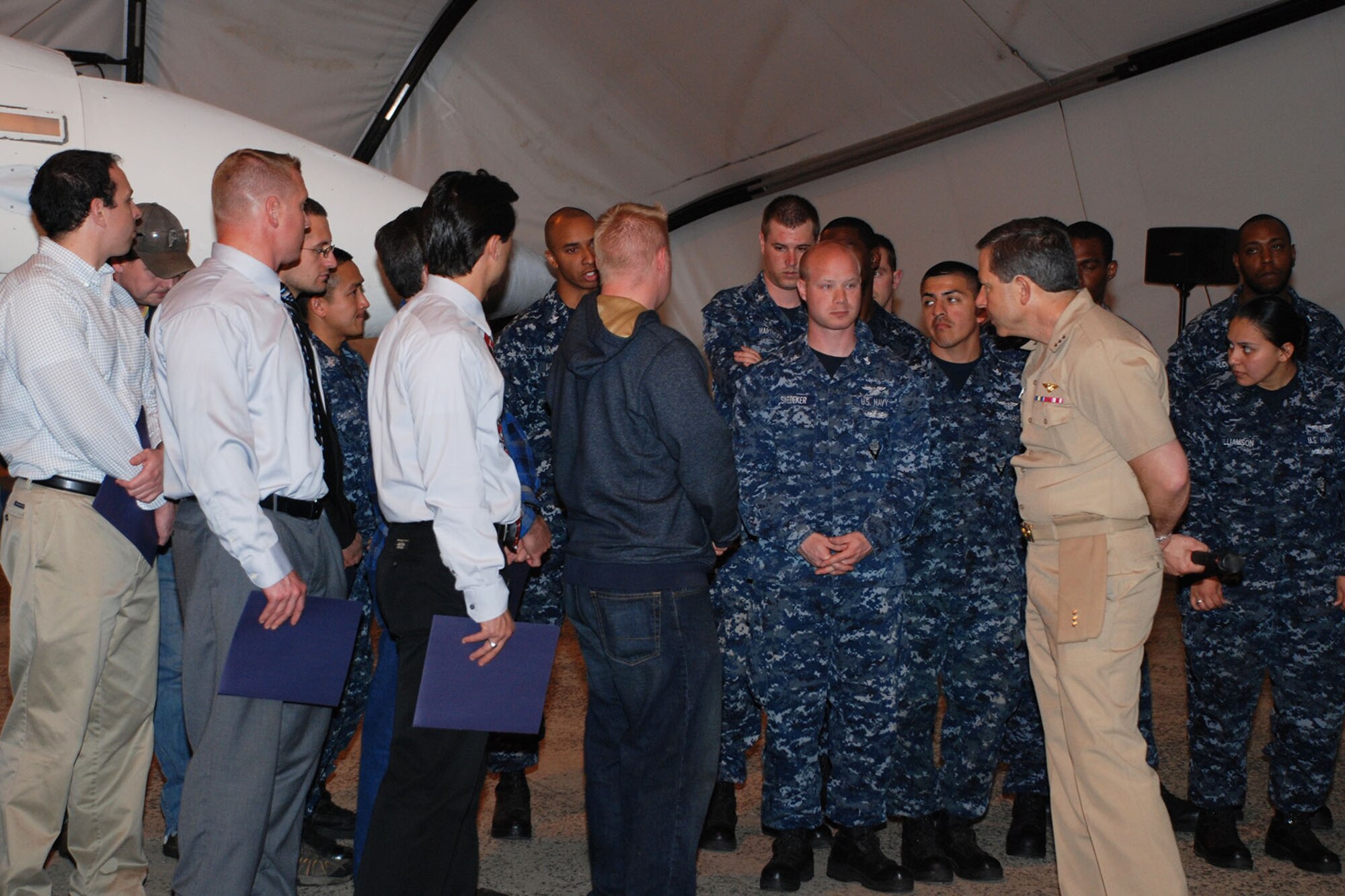 NAVAIR Commander Vice Adm. David Dunaway, right, strikes up conversations with Naval Air Warfare Center Aircraft Division Lakehurst employees after presenting them with documents recognizing their achievements in the Aircraft Launch and Recovery Equipment missions April 30, 2013, at Joint Base McGuire Dix Lakehurst, N.J. (U.S. Navy courtesy photo/Released)