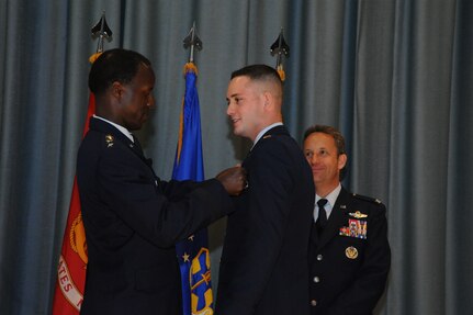 Commander of Air Education and Training Command, Gen. Edward Rice Jr., pins pilot wings on one of the newest remotely piloted aircraft pilot graduates.  The 558th Flying Training Squadron at Joint Base San Antonio-Randolph, Texas held their first undergraduate RPA training class winging ceremony May 3, 2013. Rice winged several of the Air Force’s newest RPA pilots; he also served as the guest speaker for the graduation ceremony. (U.S. Air Force photo)
