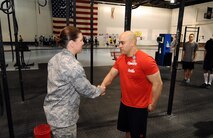 U.S Air Force Colonel Andrea Tullos, 55th Wing Mission Support Group commander, congratulates U.S. Air Force Master Sgt. David LeClaire, U.S. Strategic Command, after pinning the Air Force Achievement medal on him at the Tactical Fitness complex located in the North end of the Offutt Field House on April 26, Offutt Air Force Base, Neb. LeClaire was instrumental in getting the Tactical Fitness program introduced to Offutt AFB. (U.S. Air Force Photo by Josh Plueger/Released)
