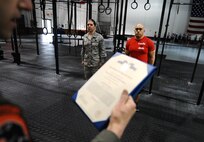Air Force Achievement Medal orders are read for U.S. Air Force Master Sgt. David LeClaire, U.S. Strategic Command, for his role in getting a CrossFit program established at the Offutt Field House, Offutt Air Force Base, Neb., April 26. LeClaire dedicates an average of 42 hours a week to the program. (U.S. Air Force Photo by Josh Plueger/Released)