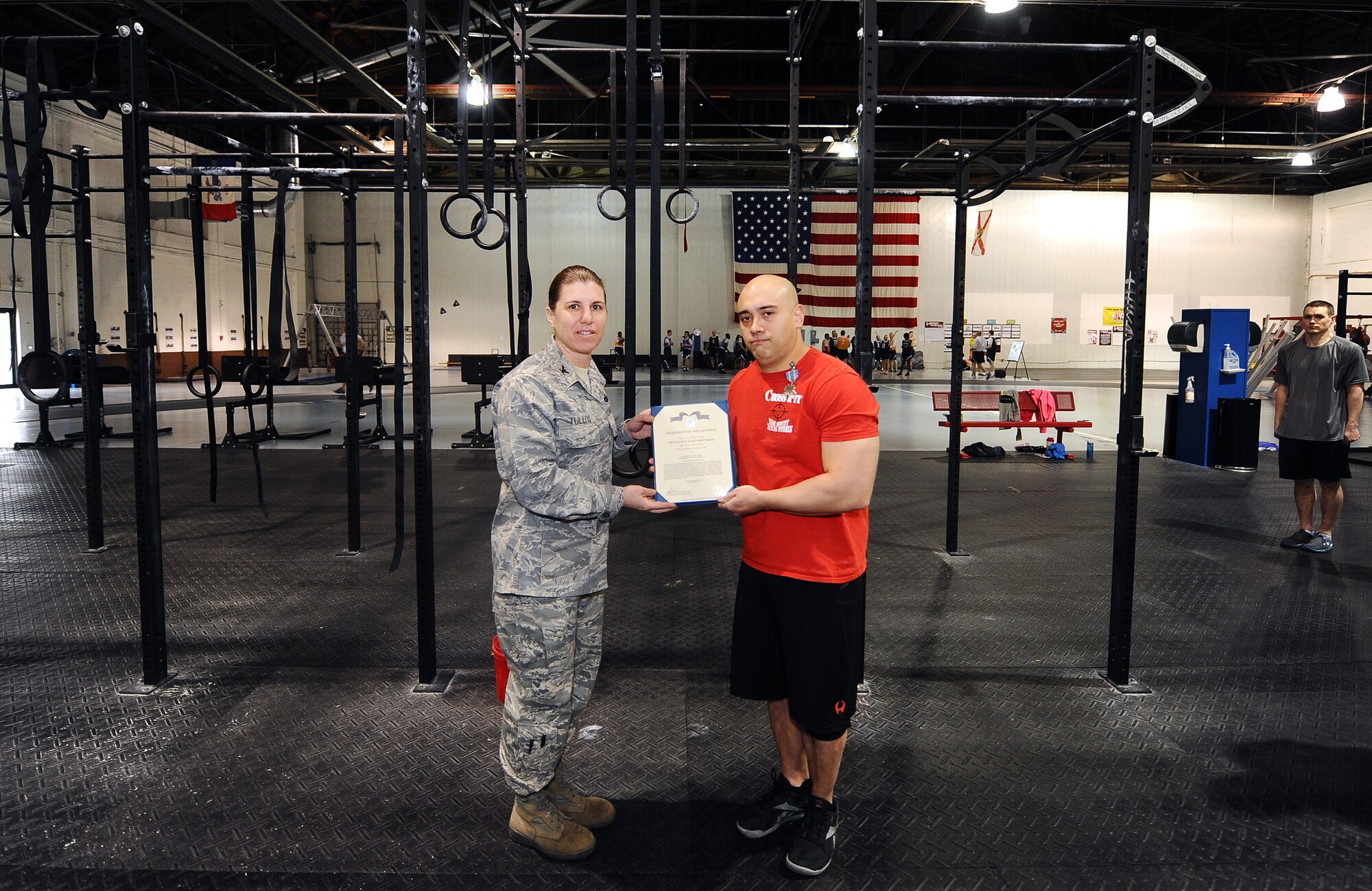 U.S. Air Force Master Sgt. David LeClaire, U.S. Strategic Command, receives the Air Force Achievement Medal from U.S. Air Force Col. Andrea Tullos, 55th Wing Mission Support Group commander, for his work with the Tactical Fitness program, Offutt Air Force Base, Neb., April 26. The TacFit program has been a huge success at Offutt, aiding in getting both military and civilians to attain peak physical fitness. (U.S. Air Force Photo by Josh Plueger/Released)