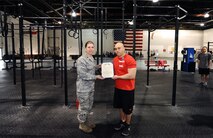 U.S. Air Force Master Sgt. David LeClaire, U.S. Strategic Command, receives the Air Force Achievement Medal from U.S. Air Force Col. Andrea Tullos, 55th Wing Mission Support Group commander, for his work with the Tactical Fitness program, Offutt Air Force Base, Neb., April 26. The TacFit program has been a huge success at Offutt, aiding in getting both military and civilians to attain peak physical fitness. (U.S. Air Force Photo by Josh Plueger/Released)