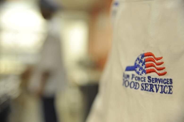 The Airmen work diligently at the Ozark Inn on Whiteman Air Force Base, Mo. April 15, 2013. The handle of the emblem represents the stability of services and the nine stars represent the nine enlisted positions. The top red stripe represents all the Air force services together and the remaining three represent the Air Force Core Values. (U.S. Air Force photo by Airman 1st Class Keenan Berry/Released)