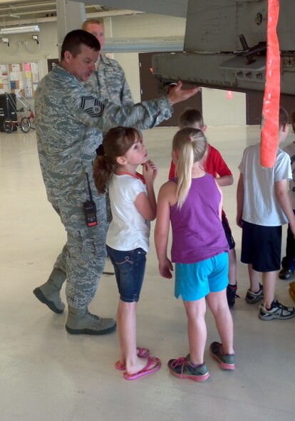 Senior Master Sgt. Dee Tankersley speaks to a group of first grade students from Mansfield Elementary School. The group toured the 188th Fighter Wing May 7, 2013. The group visited the hangar and got the chance to inspect one of the 188th’s A-10C Thunderbolt II “Warthogs.” The group also received a tour of the 188th Fire Emergency Services Flight. (U.S. Air National Guard photo by Maj. Heath Allen/188th Fighter Wing)