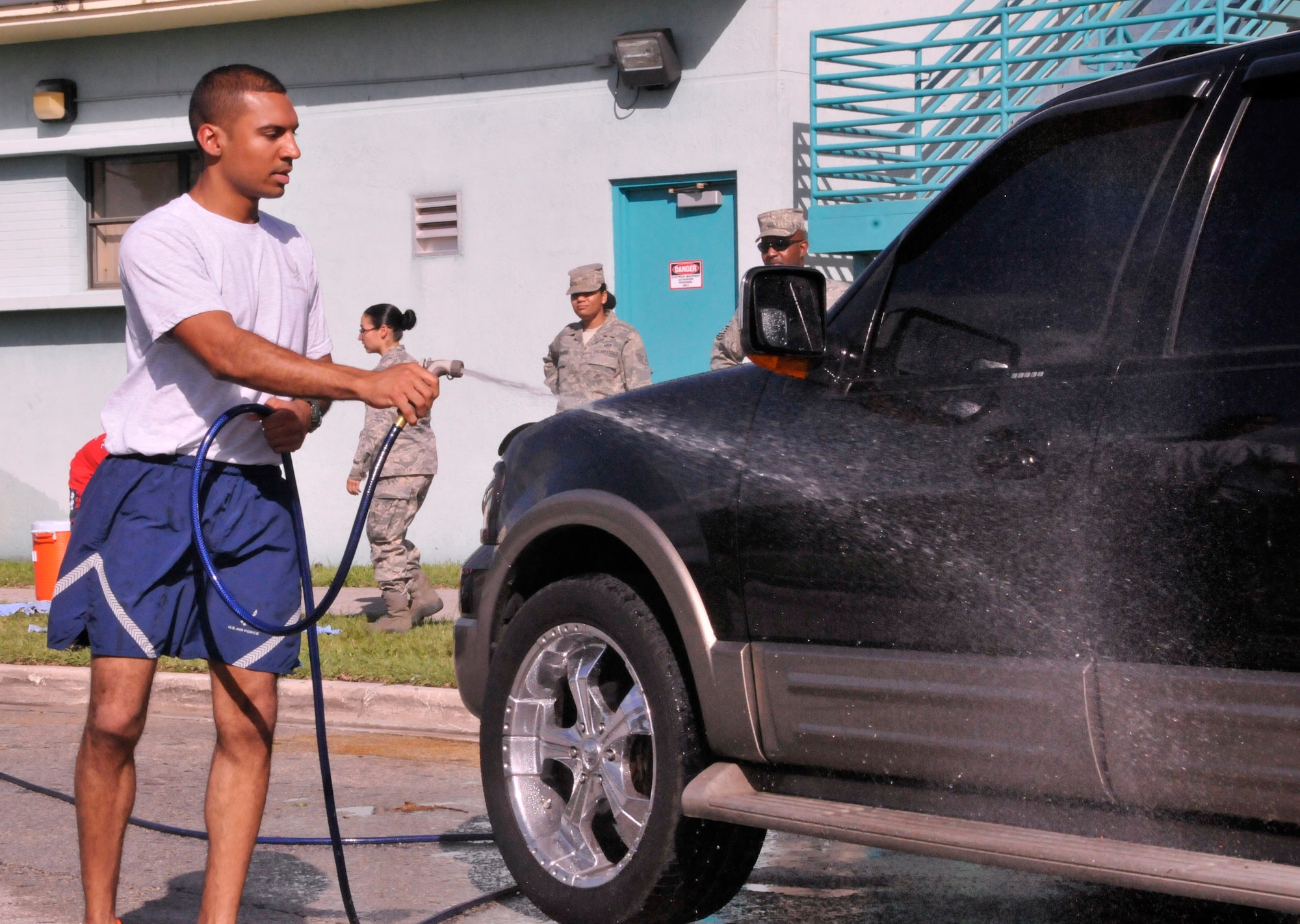 Senior Airman Julio Velezon rinses a car during a car wash at Homestead Air Reserve Base, Fla., May 4. The funds raised during the car wash went toward the base's Airman's Council. (U.S. Air Force photo/Senior Airman Jaimi Upthegrove)