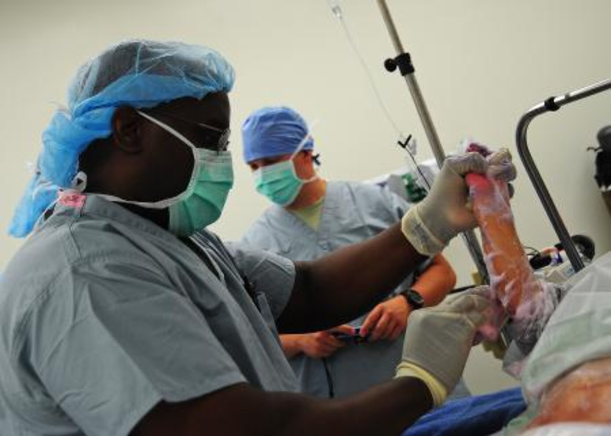 U.S. Air Force Maj. Harold McCants, operating room officer from Wilford Hall Medical Center, Texas, uses a skin cleanser on the arm of a patient prior to a syndactyly surgery during a surgery medical readiness training exercise at Northern Regional Hospital in Orange Walk, Belize, May 2, 2013. Isai Carrillo, a 4-year-old Belizean boy is undergoing a medical procedure to his right hand to correct syndactyly, a condition where the digits of the hand or foot are fused or webbed together. Military medical professionals from the U.S. are providing free medical treatment at multiple medical readiness training exercises throughout Belize as part of an exercise known as New Horizons. The MEDRETES are designed to provide humanitarian assistance and medical care to people in several communities, while helping improve the skills of U.S. military medical forces. (U.S. Air Force photo by Tech Sgt. Tony Tolley/Released)