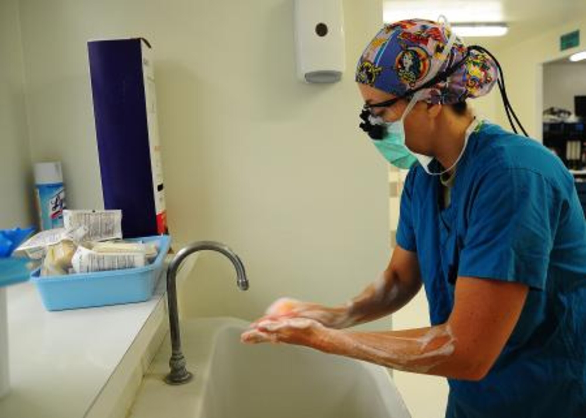 U.S. Air Force Lt. Col. Kerry Latham, plastic surgeon from Walter Reed Army Medical Center, Washington D.C., washes her hands prior to performing a syndactyly surgery during a surgery medical readiness training exercise at Northern Regional Hospital in Orange Walk, Belize, May 2, 2013. Syndactyly is a condition where the digits of the hand or foot are fused or webbed together. Military medical professionals from the U.S. are providing free medical treatment at multiple medical readiness training exercises throughout Belize as part of an exercise known as New Horizons. The MEDRETES are designed to provide humanitarian assistance and medical care to people in several communities, while helping improve the skills of U.S. military medical forces. (U.S. Air Force photo by Tech Sgt. Tony Tolley/Released)
