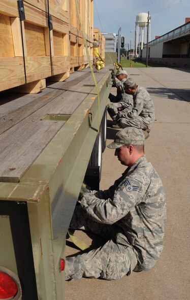 Vehicle Operators from the 2nd Logistics Readiness Squadron tie-up cargo to a tractor trailer on Barksdale Air Force Base, La., May 7, 2013. Vehicle operators must ensure cargo is properly secured to the vehicle before transporting it to its destination. (U.S. Air Force photo/Airman 1st Class Benjamin Gonsier)
