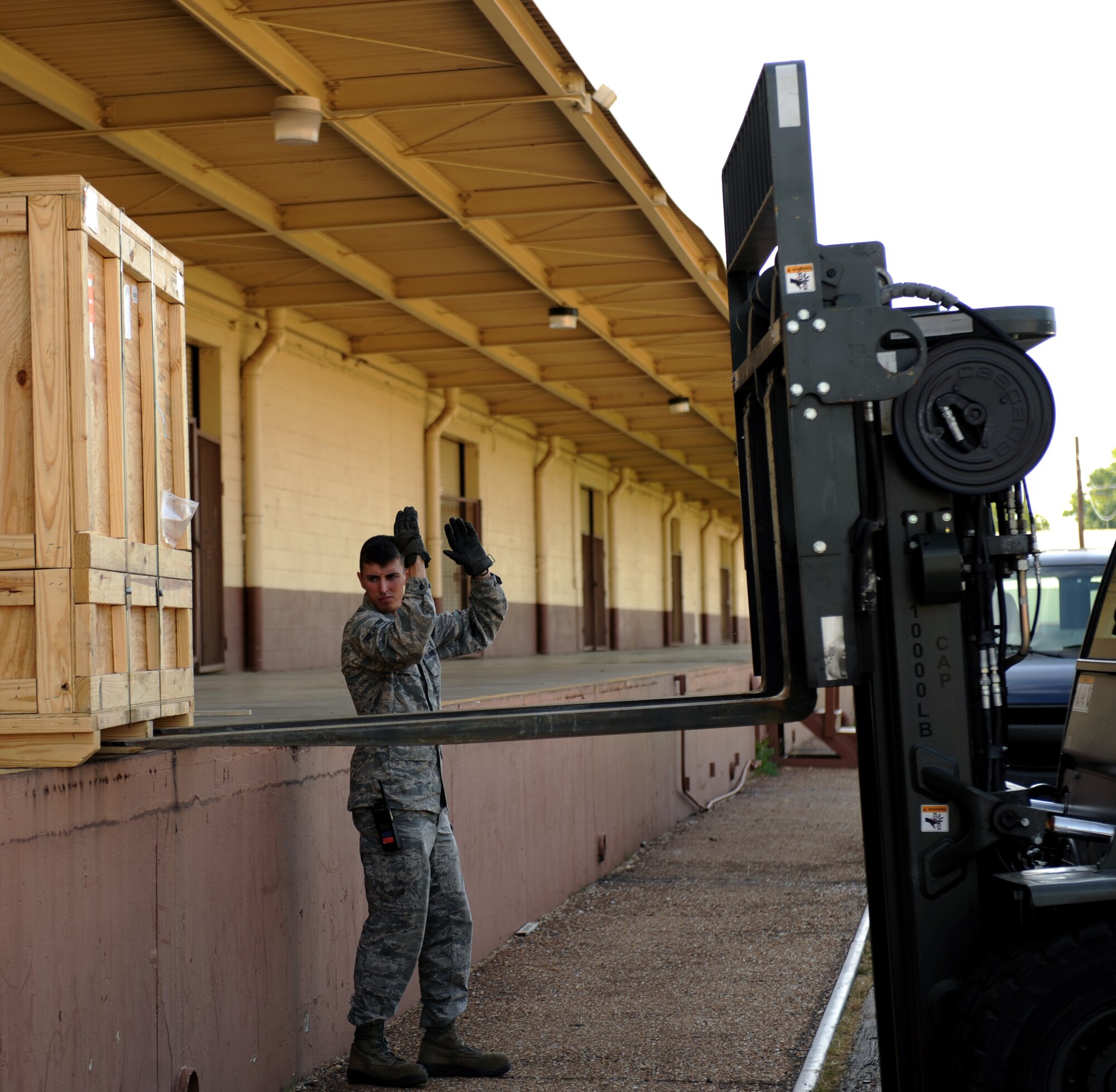 Airman 1st Class James Ott, 2nd Logistics Readiness Squadron vehicle operator, directs Senior Airman John Aultman, 2nd LRS vehicle operator, where to position his forklift on Barksdale Air Force Base, La., May 7, 2013. Vehicle operators transport aircrew members, aircraft parts, distinguished visitors and groups of people touring base. (U.S. Air Force photo/Airman 1st Class Benjamin Gonsier)  
