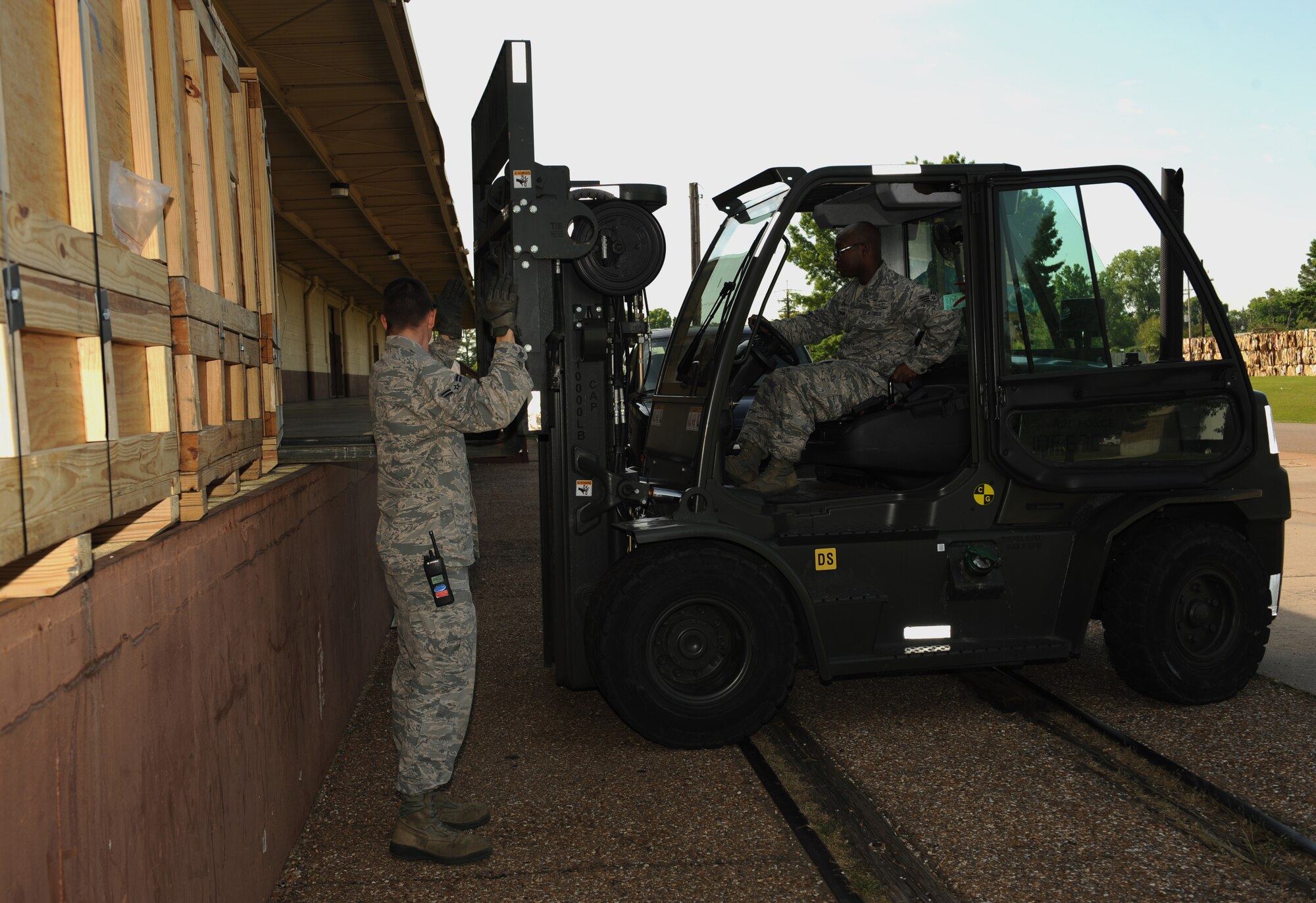 Airman 1st Class James Ott, 2nd Logistics Readiness Squadron vehicle operator, directs Senior Airman John Aultman, 2nd LRS vehicle operator, where to position his forklift on Barksdale Air Force Base, La., May 7, 2013. Vehicle operators transport aircrew members, aircraft parts, distinguished visitors and groups of people touring base. (U.S. Air Force photo/Airman 1st Class Benjamin Gonsier) 
