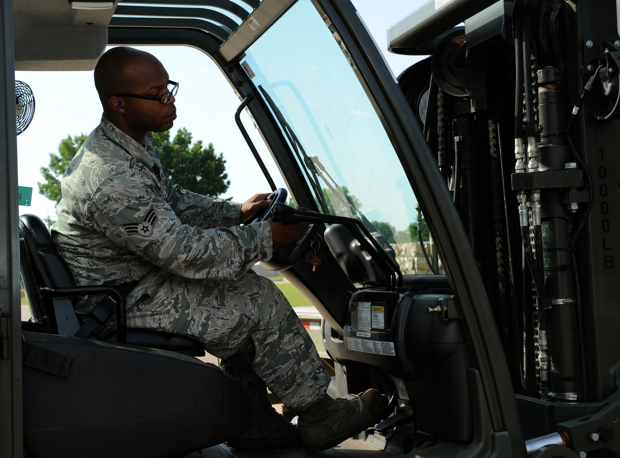 Senior Airman John Aultman, 2nd Logistics Readiness Squadron vehicle operator, operates a lever inside a forklift on Barksdale Air Force Base, La., May 7, 2013. Vehicle operators drive various vehicles which include tractor trailers, forklifts, buses and vans. (U.S. Air Force photo/Airman 1st Class Benjamin Gonsier)
