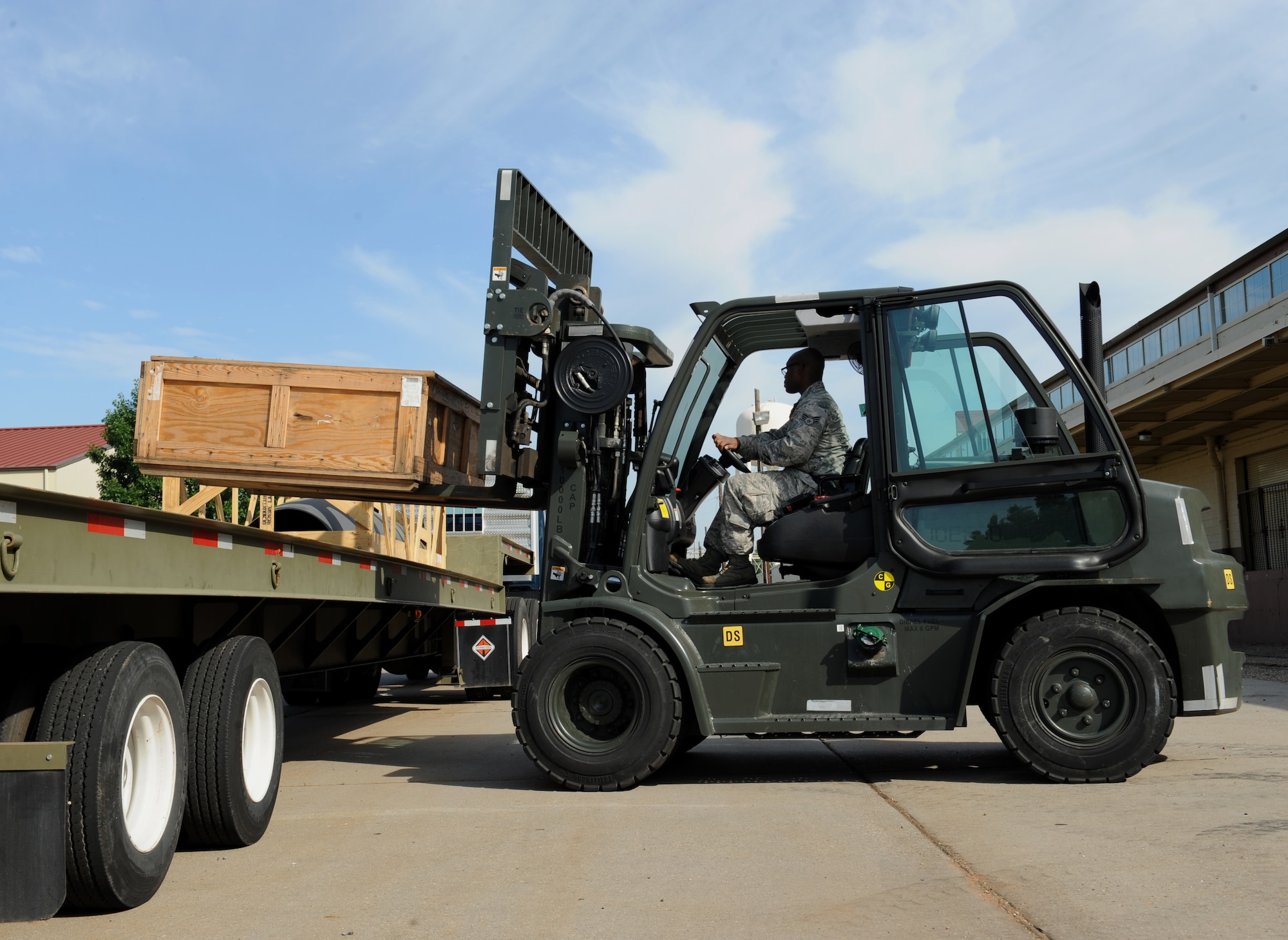 Senior Airman John Aultman, 2nd Logistics Readiness Squadron vehicle operator, places a crate on a tractor trailer while operating a forklift on Barksdale Air Force Base, La., May 7, 2013. Vehicle operators drive various vehicles which include tractor trailers, forklifts, buses and vans. (U.S. Air Force photo/Airman 1st Class Benjamin Gonsier)
