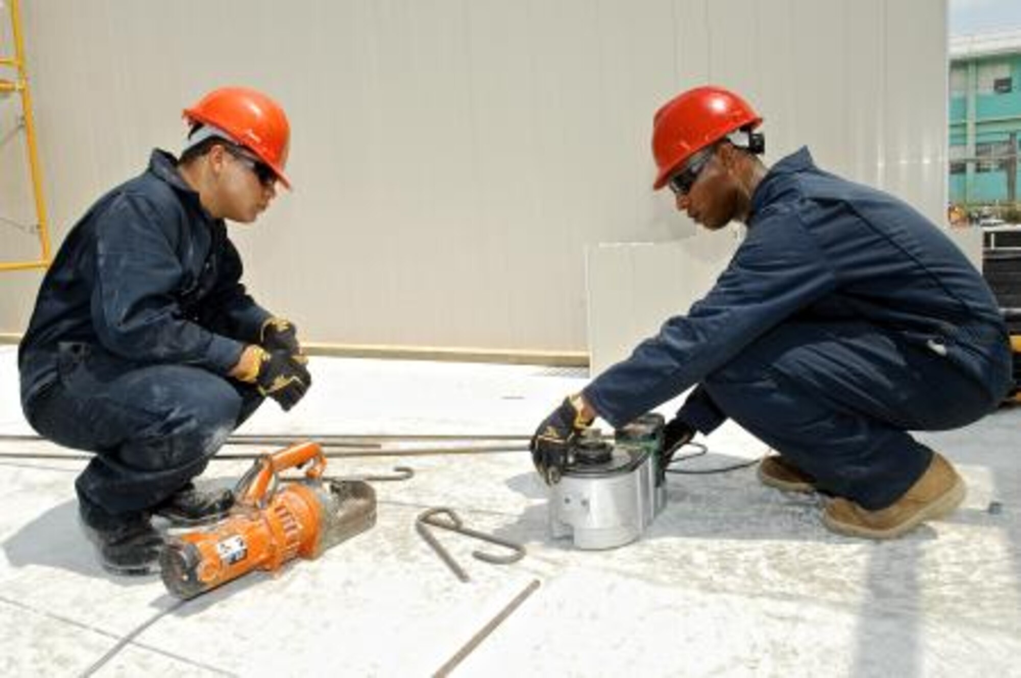 Belize Defence Force 2nd Lt. Claudio Quiroz, left, and Pvt. Francis Henkis, right, both assigned to the Light Engineer Company, cut and bend rebar, reinforcing bar, April 30, 2013, at the Trial Farm Government School construction site in Orange Walk, Belize. The New Horizons construction teams are training in Belize using the fast, stay-in-place concrete wall forming system at three of the four schools. Civil engineers from both the U.S. and Belize are constructing various structures at schools throughout Belize as part of an exercise called New Horizons. Building these facilities will support further education for the children of the country and provide valuable training for U.S. and Belizean service members. (U.S. Air Force photo/ Master Sgt. James Law)
