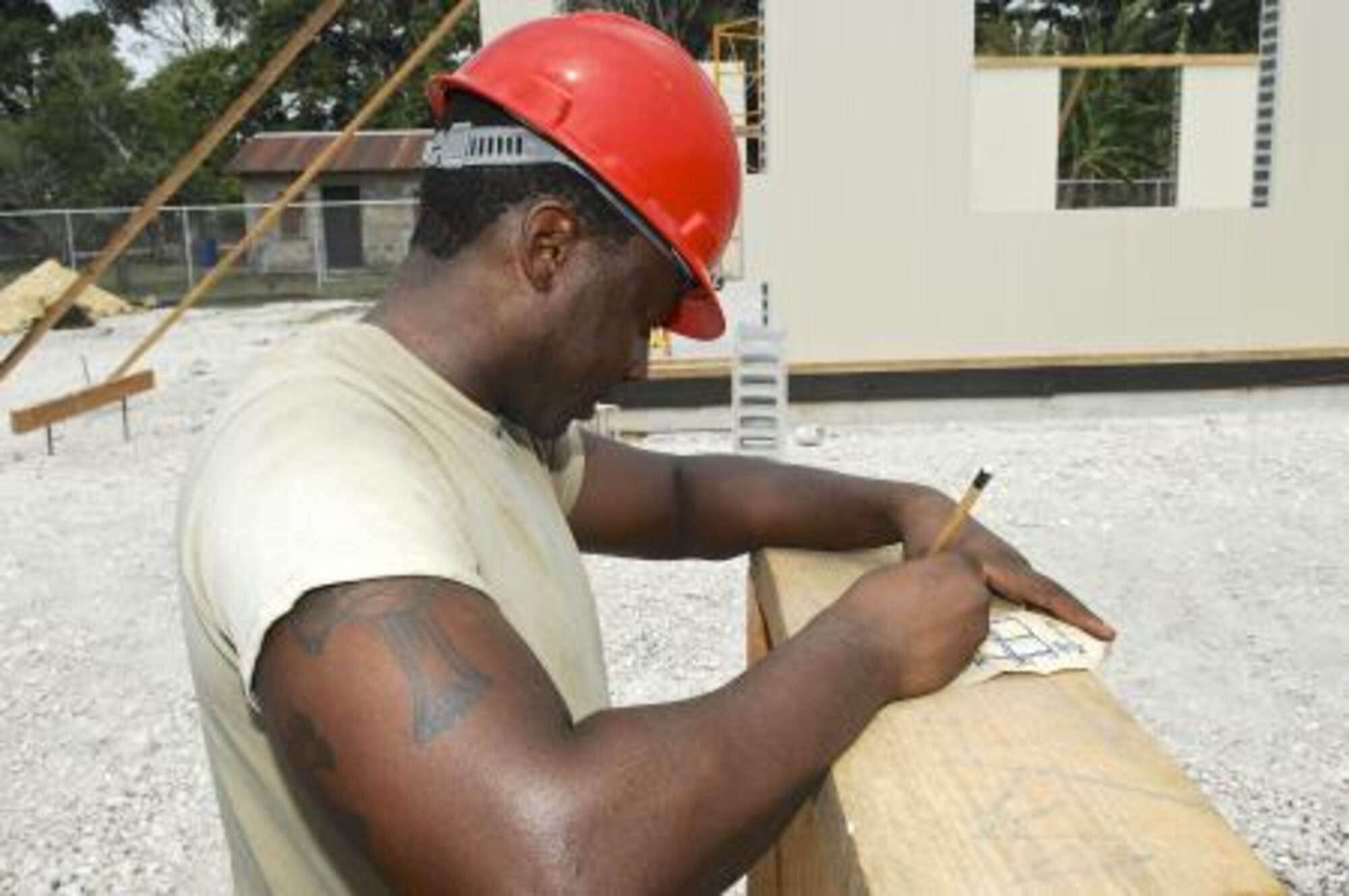 U.S. Air Force Senior Airman Eric King, assigned to the 823rd RED HORSE Squadron, checks the measurements for a window brace April 30, 2013, at the Trial Farm Government School construction site in Orange Walk, Belize. Civil engineers from both the U.S. and Belize are constructing various structures at schools throughout Belize as part of an exercise called New Horizons. Building these facilities will support further education for the children of the country and provide valuable training for U.S. and Belizean service members. (U.S. Air Force photo/ Master Sgt. James Law)