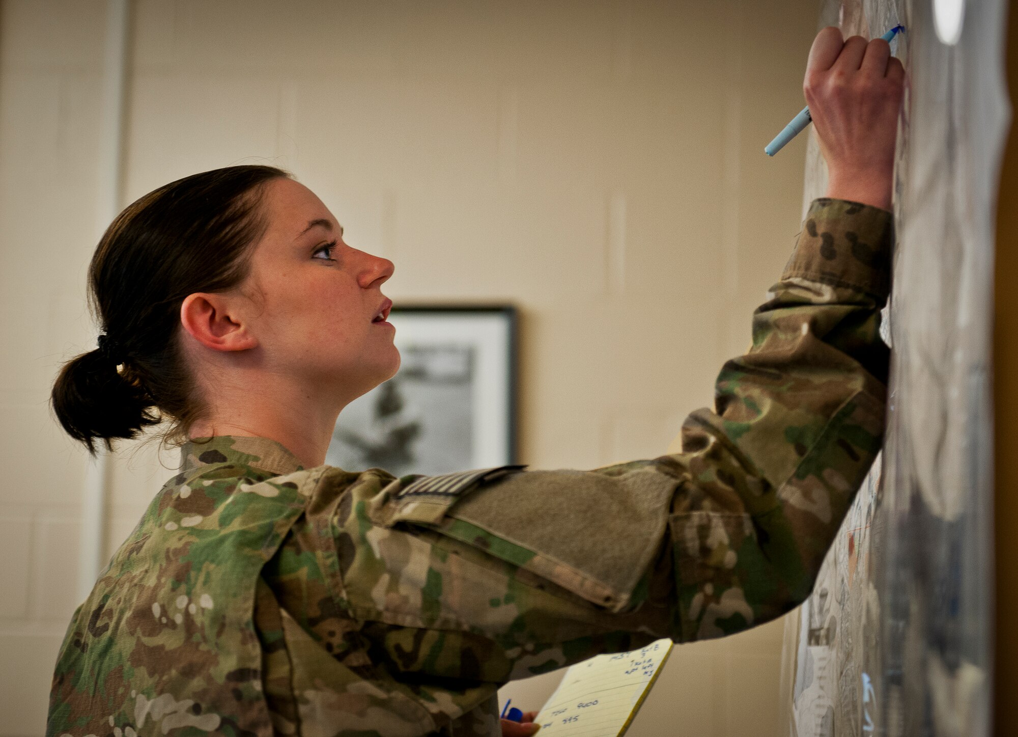 Staff Sgt. Danielle Keister, of the 460th Security Forces Squadron from Buckley Air Force Base, Colo., plots the location of a security incident on a map during a Joint Defense Operations Center exercise at Eglin AFB, Fla., May 4.  The exercise simulated real-world force protection conditions at Kandahar Air Field, Afghanistan, to help deployers have specific location training before arriving to their new assignment.  The training was facilitated by the 96th Ground Combat Squadron.  (U.S. Air Force photo/Samuel King Jr.)