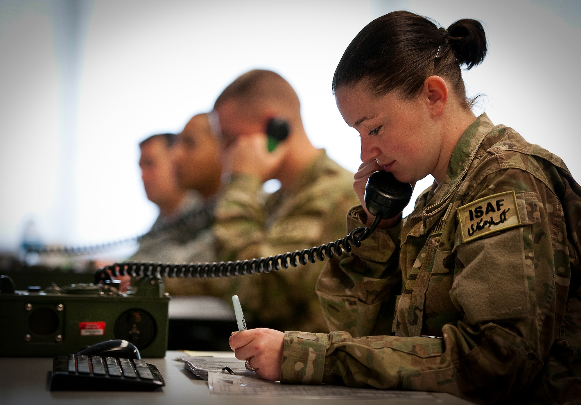 Staff Sgt. Danielle Keister, of the 460th Security Forces Squadron from Buckley Air Force Base, Colo., serves as the watch keeper, passing information via a secure phone during a Joint Defense Operations Center exercise at Eglin AFB, Fla., May 4.  The exercise simulated real-world force protection conditions at Kandahar Air Field, Afghanistan, to help deployers have specific location training before arriving to their new assignment.  The training was facilitated by the 96th Ground Combat Squadron.  (U.S. Air Force photo/Samuel King Jr.)
