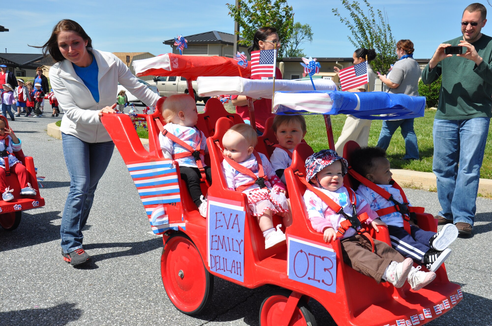 Babies from the Older Infant 3 classroom of the Child Development Center ride in a parade around the Child Development Center May 3, 2013, on Dover Air Force Base, Del. The parade, postponed from its original April 30 date due to inclement weather, closed out a month of activities honoring Month of the Military Child. (U.S. Air Force photo/Master Sgt. Veronica Aceveda)