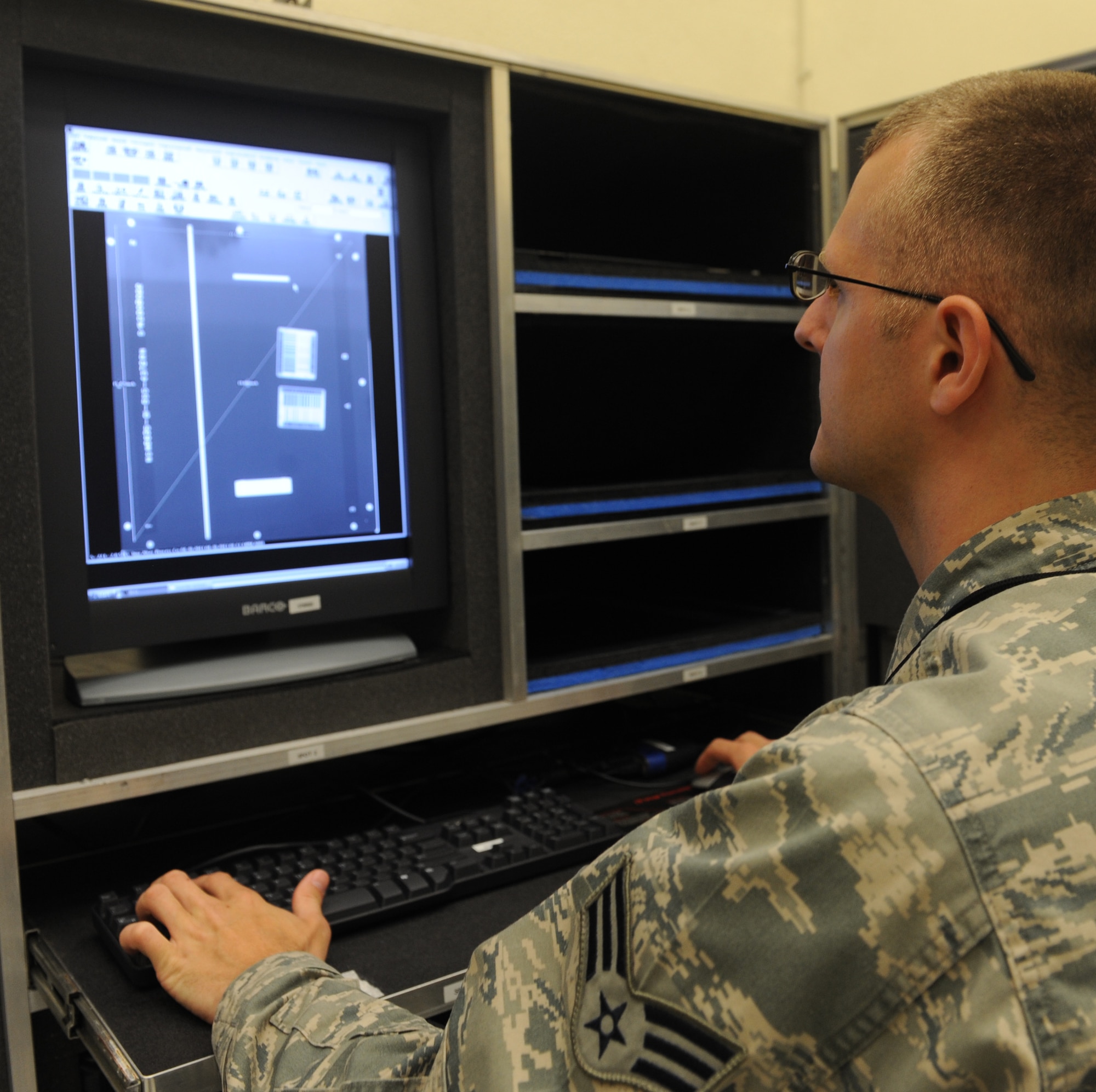 Senior Airman Joel Flowers, 509th Maintenance Squadron non-destructive inspection journeyman, reviews an x-ray of an aircraft part at Whiteman Air Force Base, Mo., May 1, 2013. The NDI shop has 12 full-time Airmen who work in two shifts, with someone always on call. (U.S. Air Force photo by Airman 1st Class Bryan Crane)
