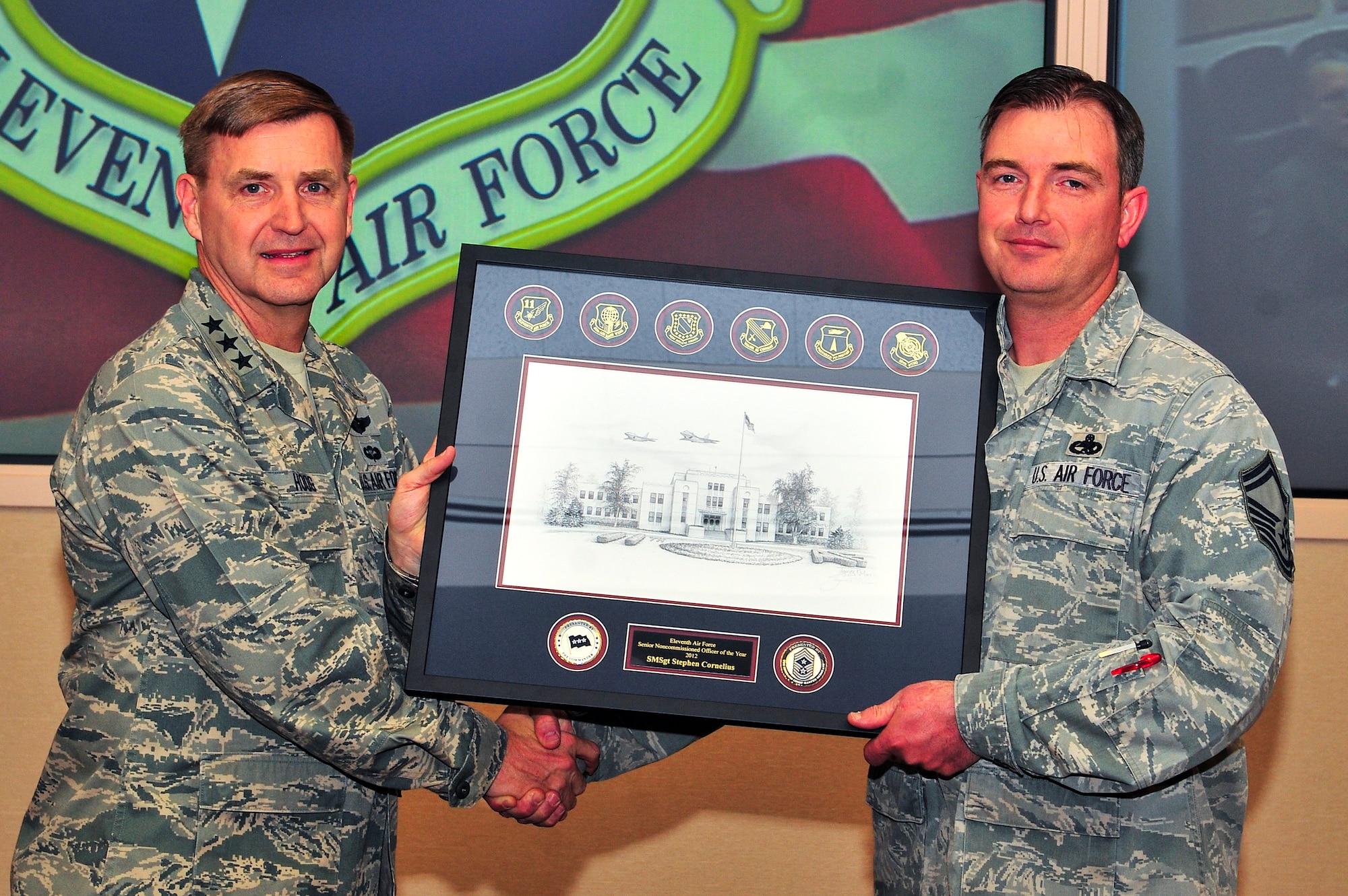 U.S. Air Force Lt. Gen. Stephen Hoog, 11th Air Force commander, presents Senior Master Sgt. Stephen Cornelius, 354th Aircraft Maintenance Squadron Aircraft Maintenance Unit superintendent,  with the 2012 11th Air Force Senior Noncommissioned Officer of the Year award during a briefing May 1, 2013, Eielson Air Force Base, Alaska. (U.S. Air Force photo by Senior Airman Racheal E. Watson)