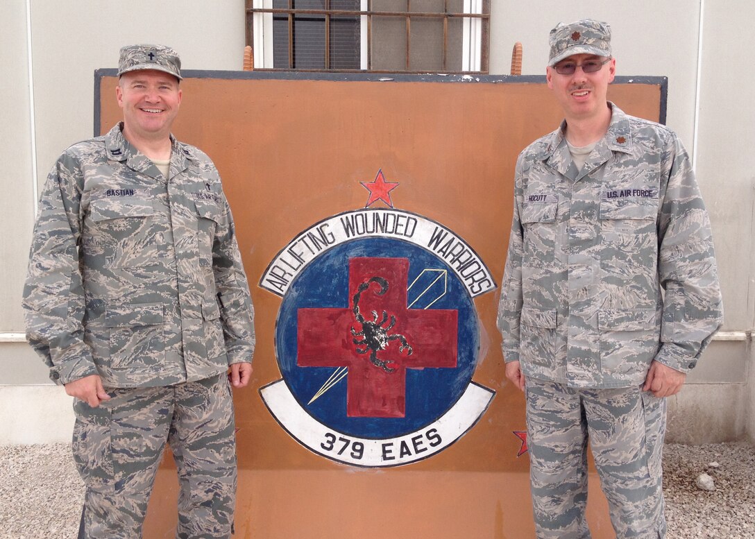 Chaplain (Capt.) James Bastian (pictured left), 914th Airlift Wing, and Maj. Michael Hocutt, 914th Aeromedical Evacuation Squadron, pose in front of the 379th Expeditionary Aeromedical Evacuation Squadron facility May 1, 2013 at a base in Southwest Asia.  Both men are currently deployed from the Niagara Falls Air Reserve Station, N.Y.  (Courtesy Photo)