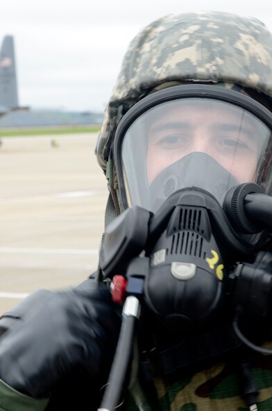 U.S. Air Force Staff Sgt. Trent Otto, a firefighter with the Rosecrans Fire Department, Missouri Air National Guard, demonstrates equipment that would be used in a chemical environment during Task Qualification Training (TQT) at Rosecrans Air National Guard Base, Mo., May 4, 2013. The base conducted TQT to prepare for an operational readiness inspection next year which tests Airmen’s ability to survive and operate in a war time environment. (U.S. Air National Guard photo by Senior Airman Patrick P. Evenson/Released)