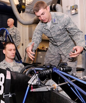 Cadet 1st Class Jeffrey DesRoches (right) explains design and engineering choices cadets made while building a Formula race car to Capt. Robert Bailey III in the Engineering Mechanics Lab May 1, 2013. Bailey is the deputy lab director and the Air Force Academy's Formula race car team adviser. (U.S. Air Force photo/Sarah Chambers)