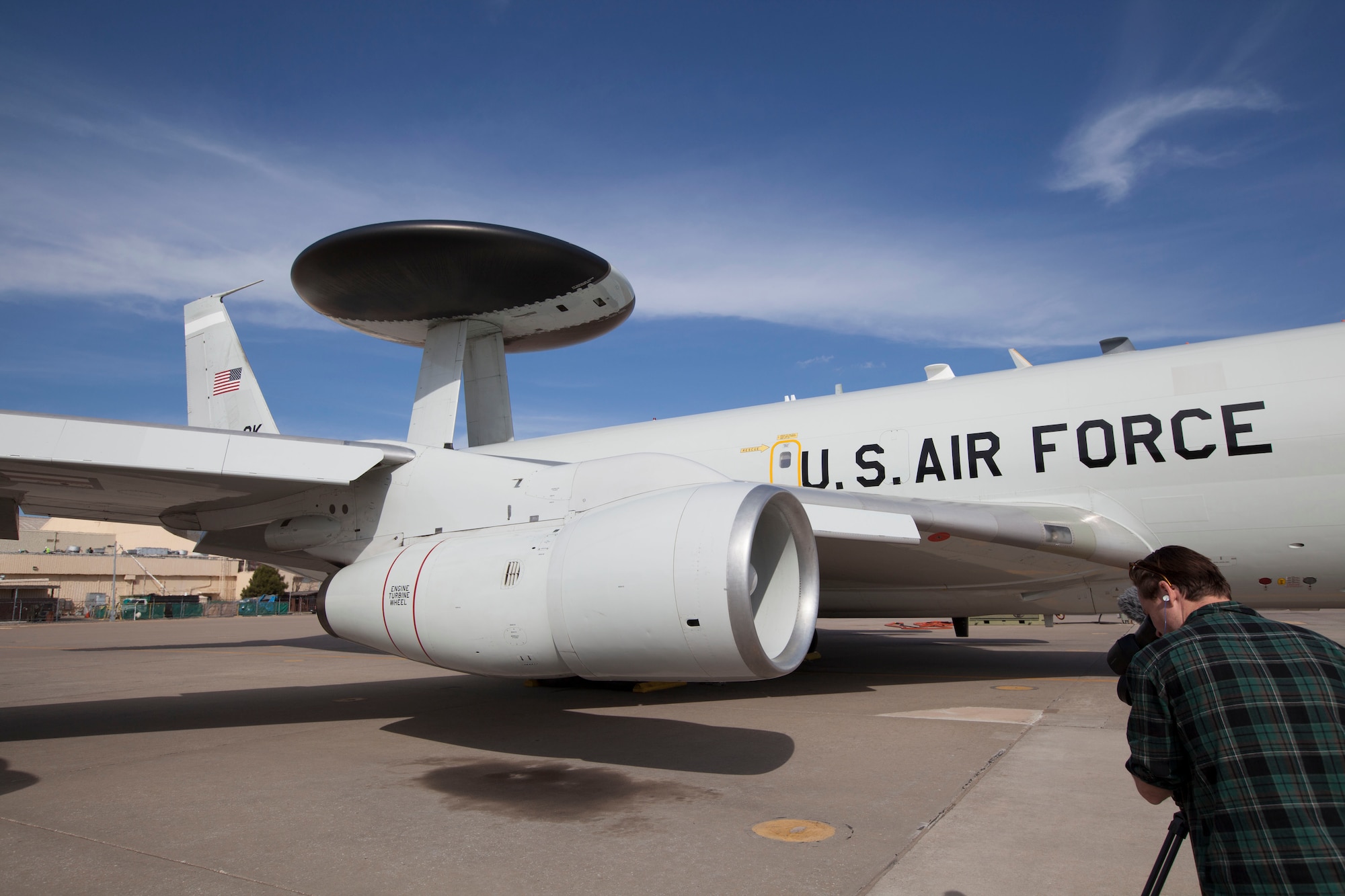 Cory Johnson from the popular television show “The Aviators” takes video of a E-3 Sentry. The crew came to Tinker Air Force Base March 20-21 to feature the KC-135 and E-3 missions for an episode to air in October. (Photo by Megen Andersen)