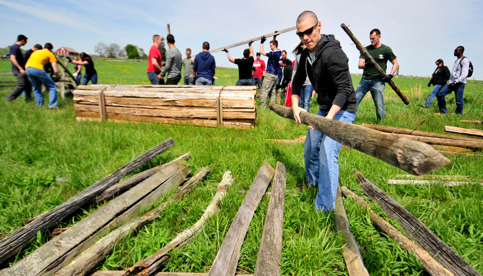 Airman 1st Class Zac Lacy, 436th Maintenance Squadron hydraulic systems specialist, throws rail from an old virignia fence into a pile May 3, 2013, at Gettysburg National Military Park in Gettysburg, Pa. More than 125 members of Team Dover helped clean the national treasure as part of the Adopt-a-Position program. (U.S. Air Force photo/Tech. Sgt. Chuck Walker)