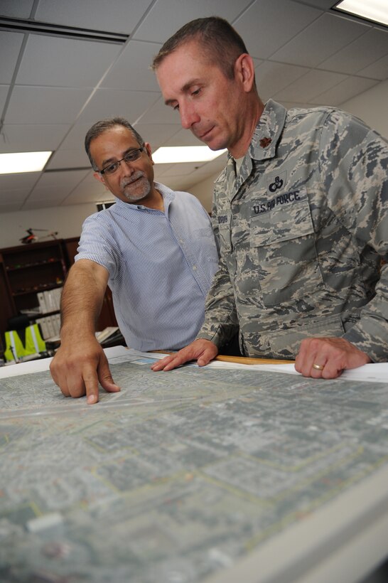 Tarun Chowdhary, 81st Operations Support Flight terminal instrument procedures specialist, and Maj. Troy Kirkbride, 81st OSF commander, review airspace obstructions May 3, 2013, at Keesler Air Force Base, Miss.  Airfield Operators perform and manage airfield operations functions and activities, including air traffic control, airfield management, and base operations to facilitate the flying mission at their base. They provide staff supervision and technical assistance, as well as develop and formulate plans and policies for managing and operating Air Force airfield operations.  (U.S. Air Force photo by Kemberly Groue)
