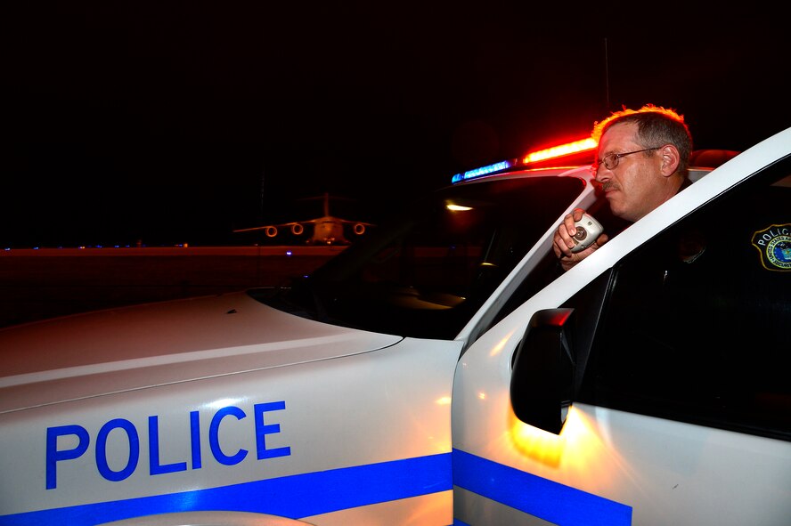 Department of Defense police officer Daniel Dobson from the 436th Security Forces Squadron poses for a photo in front of his patrol vehicle may 6th, 2013, at Dover Air Force Base, Delaware. The 436th SFS will be participating in the upcoming events that support National Police Week May 11th 2013. (U.S. Air Force photo/David S. Tucker)