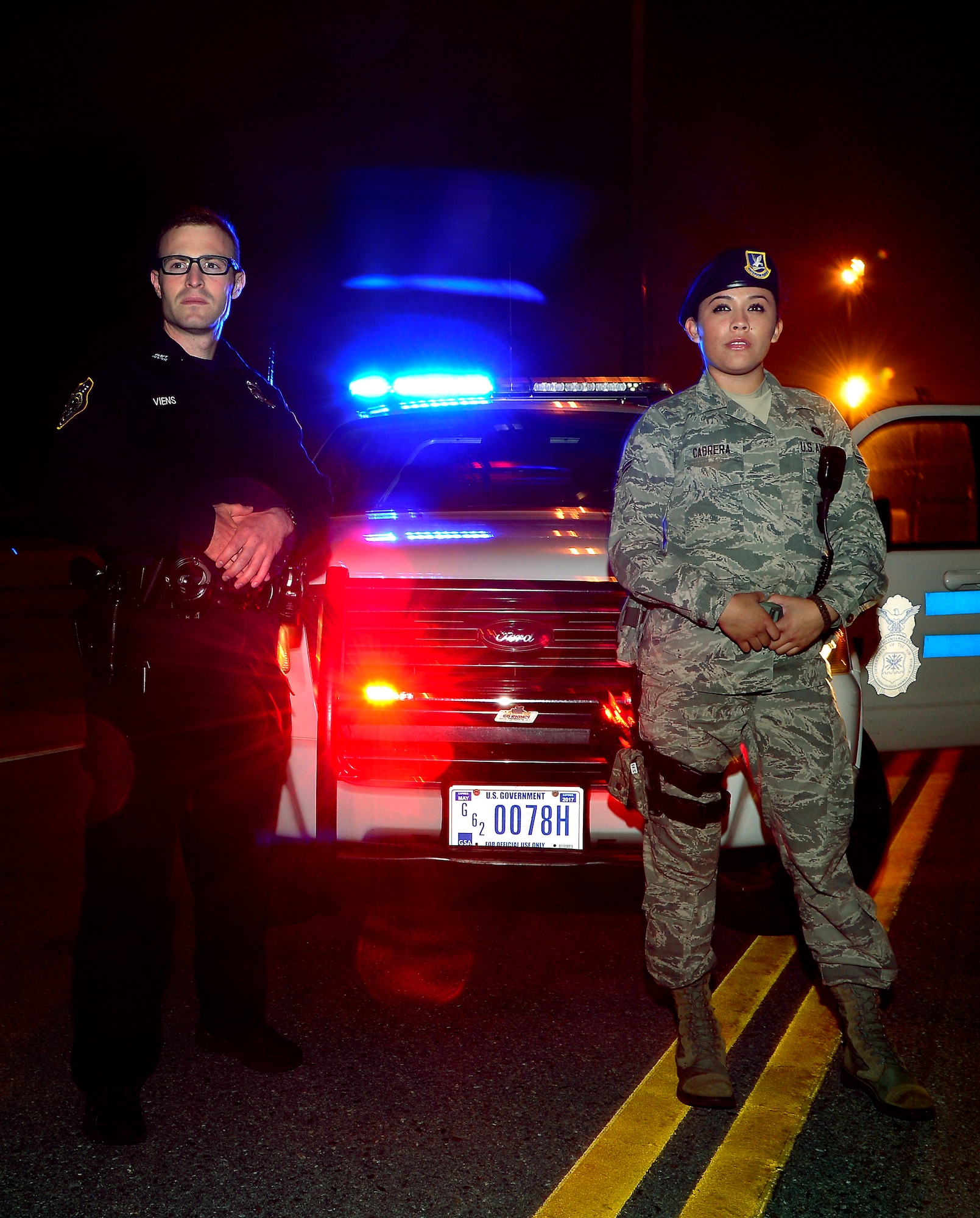 Department of Defense police officer Justin Viens (left) and Airman 1st Class Amanda Cabrera from the 436th Security Forces Squadron pose for a photo in front of their patrol vehicle may 6th, 2013, at Dover Air Force Base, Delaware. The 436th SFS will be participating in the upcoming events that support National Police Week May 11th 2013. (U.S. Air Force photo/David S. Tucker)