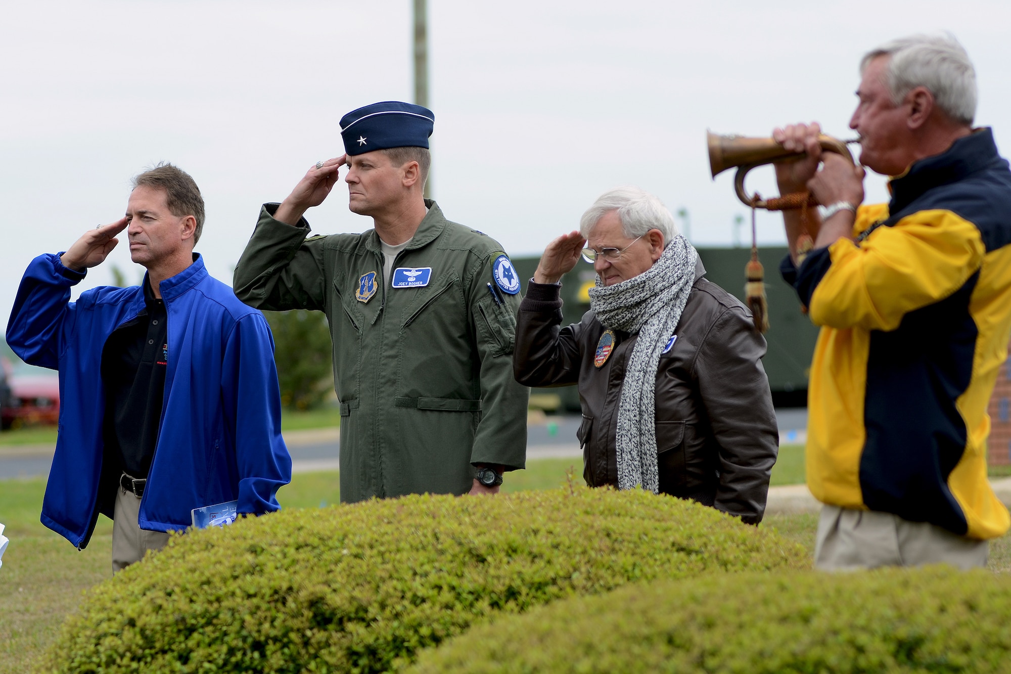 U.S. Air Force retired fighter pilots from the South Carolina Air National Guard, salute the U.S. flag as taps is played during a pilot reunion ceremony at McEntire Joint National Guard Base, Eastover, S.C., May 4, 2013. Multi-generation SCANG pilots dating back from the P-51 propeller fighter era to present converged to honor fallen comrades and celebrate their experiences and contributions to fighter operations and the legacy of the SCANG Swamp Foxes.  (U.S. Air National Guard photo by Tech. Sgt. Caycee Watson/Released)