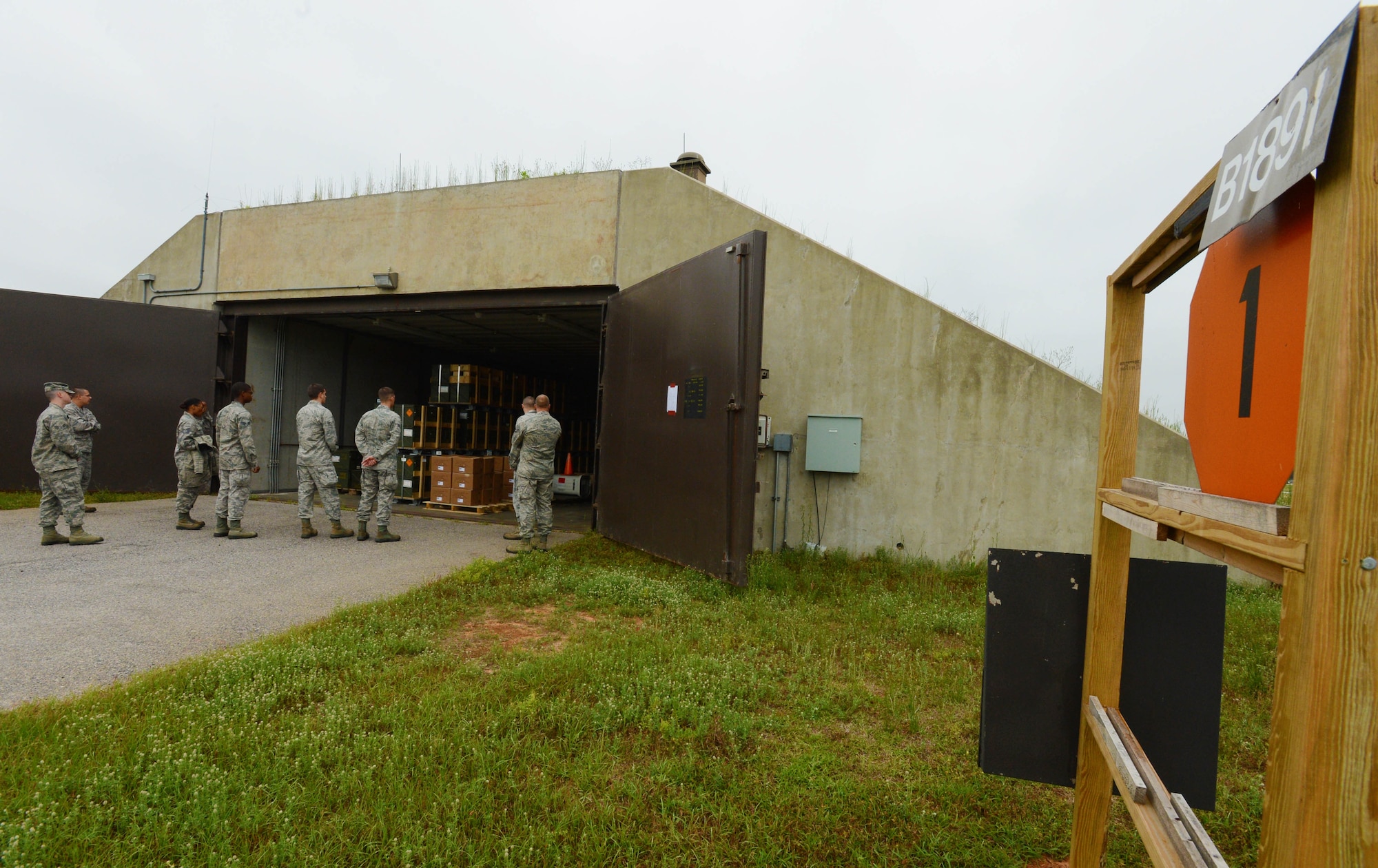 Approximately 10 Airmen from 20th wing staff agencies, tour an ammunitions storage igloo at the bomb dump, Shaw Air Force Base, S.C., May 3, 2013. The purpose of the tour was to bring Airmen from outside the career field in to experience bomb building. During the tour of the bomb dump, Airmen were shown how to build dummy bombs and missiles and had a chance to build them as well. (U.S. Air Force photo by Senior Airman Tabatha Zarrella/Released)
